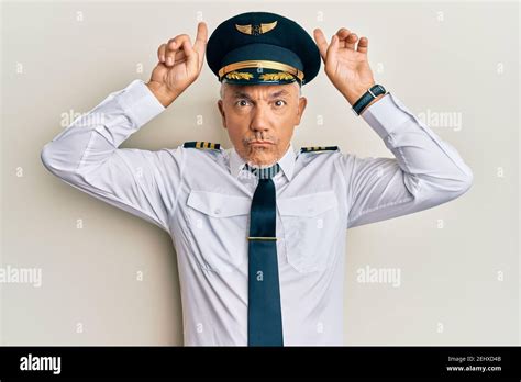 Handsome Middle Age Mature Man Wearing Airplane Pilot Uniform Doing