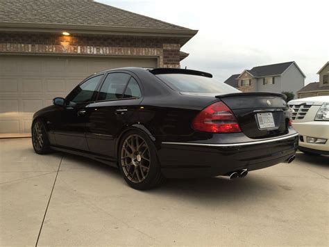 A Black Car Parked In Front Of A House