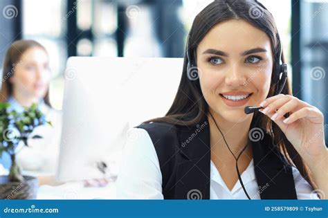 Portrait Of Call Center Worker Accompanied By His Team Smiling