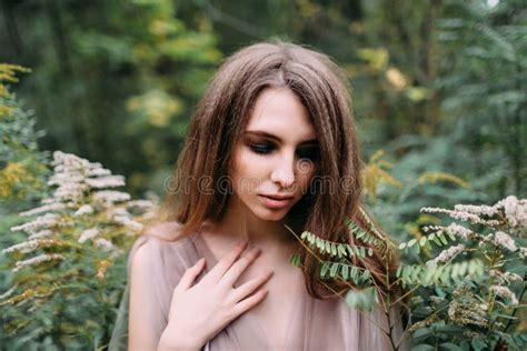 Portrait Of Beautiful Caucasian Girl With Eyes Closed In Green Leaves