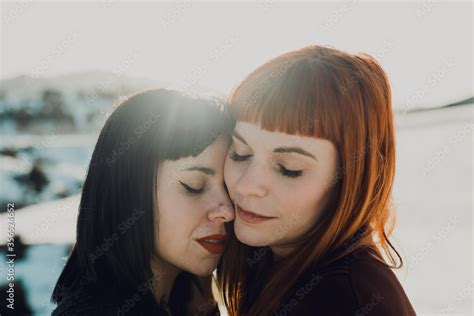 Side View Of Modern Sensual Lesbian Couple In Love Embracing While