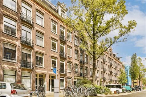 A Brick Apartment Building With Bikes Parked Outside Of It Editorial