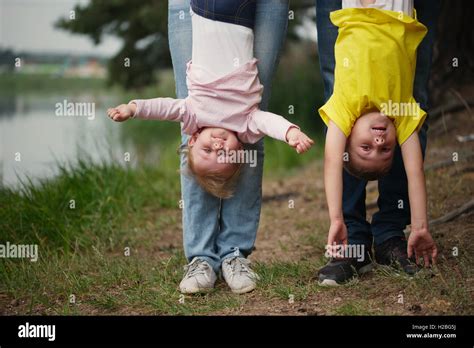 Mother And Father Holding Children Upside Down Stock Photo Alamy