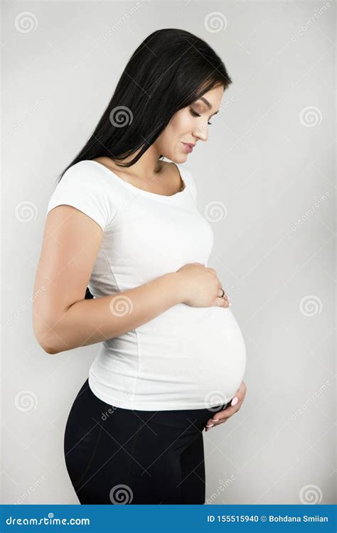 Beautiful Pregnant Brunette Woman Holding Her Pregnant Belly With Love