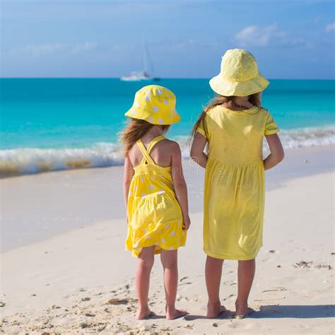 Kleine Aanbiddelijke Meisjes In Aardige Kleding Op Het Strand Stock