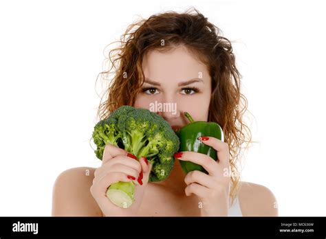 Young Smiling Woman Holding Broccoli And Green Pepper Isolated On