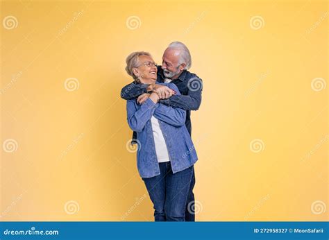 Portrait Of Loving Affectionate Senior Couple Holding Hands And Embracing While Looking At Each