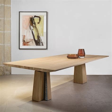 A Wooden Table With Two Vases On It In Front Of A Painting And Framed