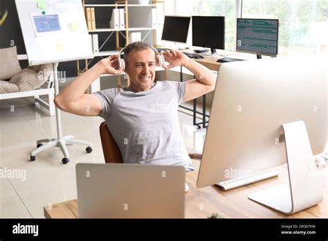 Mature Male Programmer Working In Light Office Stock Photo Alamy