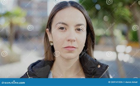 Young Beautiful Hispanic Woman Standing With Serious Expression At Park