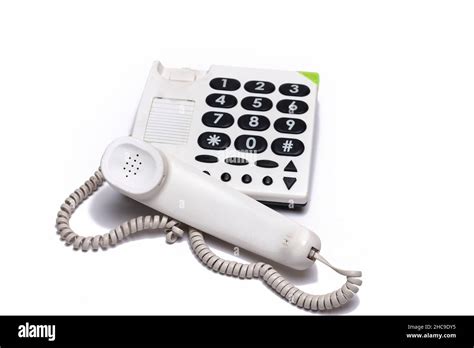 Close Up Of White Landline Phone With Large Buttons Isolated On White