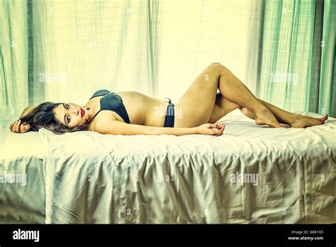 Asia Woman Black Bikini Posing On White Bed Vintage Effect Stock Photo