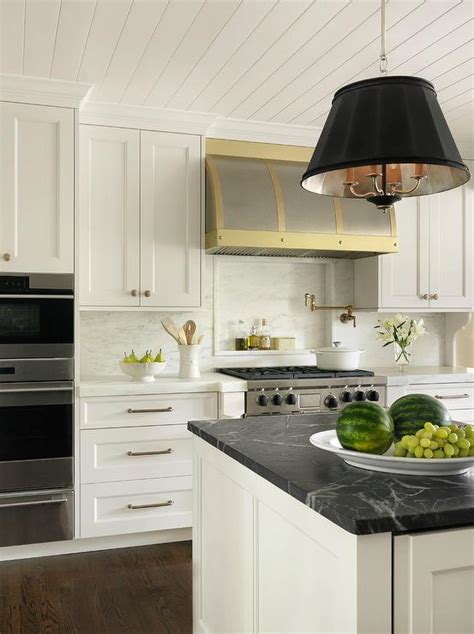 White And Gold Kitchen With Honed Black Marble Countertops