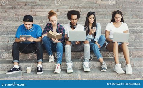 Multiethnic Teen Friends Studying And Networking Outdoor Stock Image