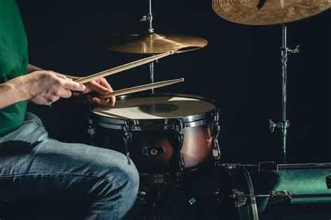 Un Hombre Toca El Tambor Contra Un Fondo Oscuro Foto Premium