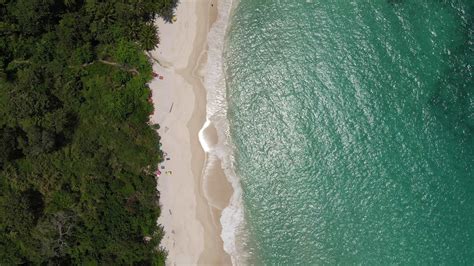 Aerial View Of Sand Beach And Water Surface Texture Foamy Waves With Sky Beautiful Tropical