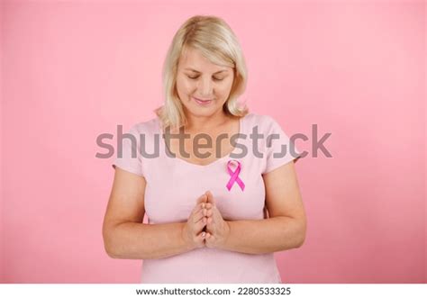 Mature Woman Praying On Pinck Background Stock Photo 2280533325