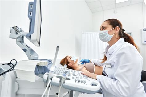 Premium Photo Woman Getting Ultrasound Of A Thyroid From Doctor