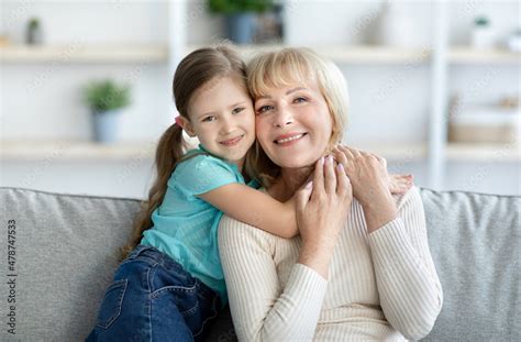 Portrait Of Happy Mature Woman And Granddaughter Hugging And Posing Stock Photo Adobe Stock