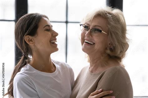 Close Up Laughing Mature Mother And Adult Daughter Enjoying Tender