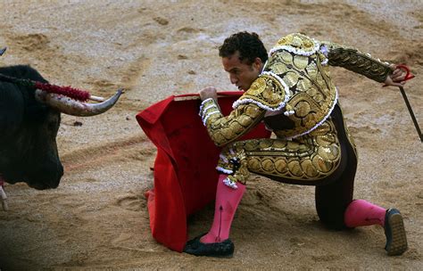 Spanish Bullfighter Rafaelillo Kneels Down In Front Of A Bull During