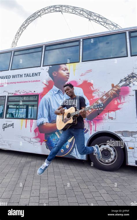 London, UK. 21 July 2017. Musician Jay Johnson jumps in front of a bus featuring his image. Dire ...