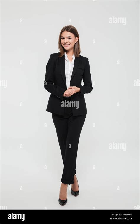 Full Length Portrait Of Smiling Attractive Businesswoman In Suit Posing