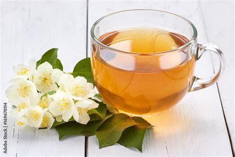 Jasmine tea and jasmine flowers on a white wooden table Stock Photo ...