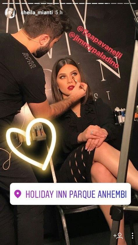 A Woman Is Getting Her Hair Done By A Man In Black Shirt And Skirt With