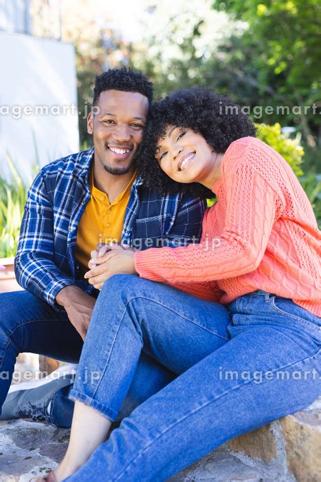 Happy African American Couple Embracing And Holding Hands On Stairs In