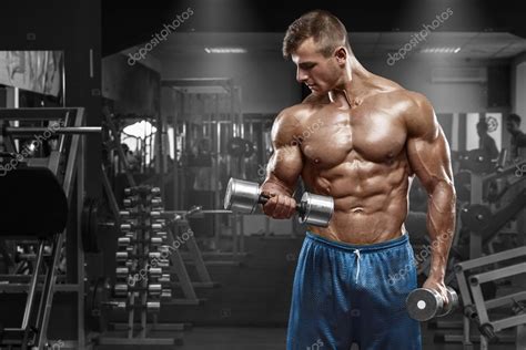 Muscular Man Working Out In Gym Doing Exercises With Dumbbells At Biceps Strong Male Naked