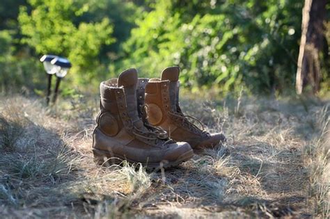 Premium Photo | Hiking boots on the ground in forest