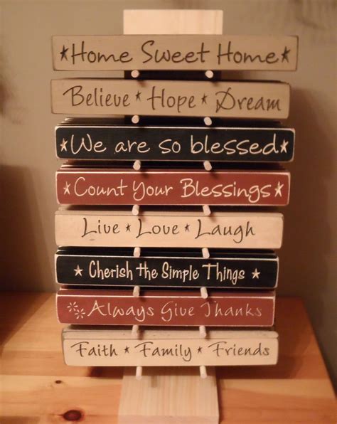 A Stack Of Wooden Signs Sitting On Top Of A Table