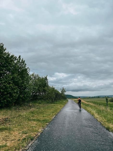 Premium Photo Cycling During Rainy Weather Concept Of Tiding A Bike