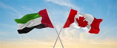 Two Crossed Flags Canada And United Arab Emirates Waving In Wind At