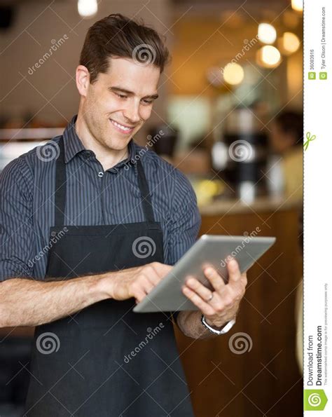 Male Owner Using Digital Tablet In Cafeteria Stock Photo Image Of