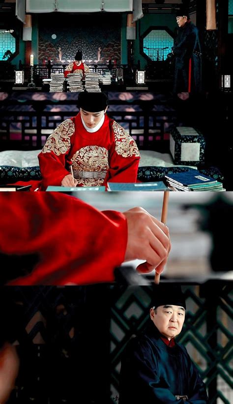 A Man In Traditional Chinese Clothing Writing On A Piece Of Paper