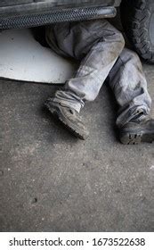 Mechanic Uniform Lying Down Working Under Stock Photo 1673522638