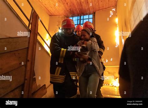 Brave Fireman Descends Stairs Of A Burning Building And Holds Saved