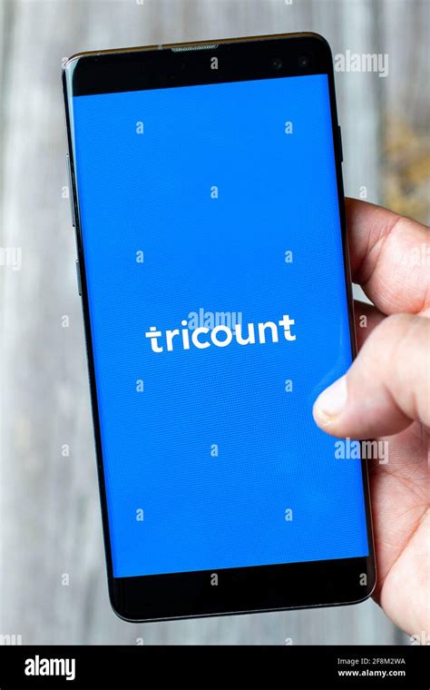 A Mobile Phone Or Cell Phone Being Held In A Hand Showing The Tricount