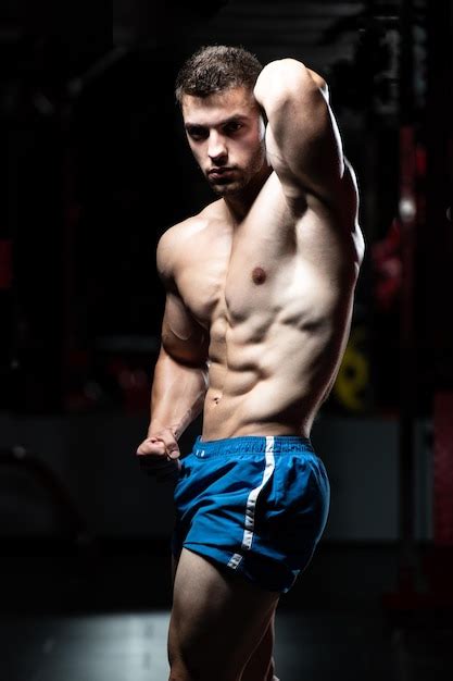 Premium Photo Serious Bodybuilder Standing In The Gym