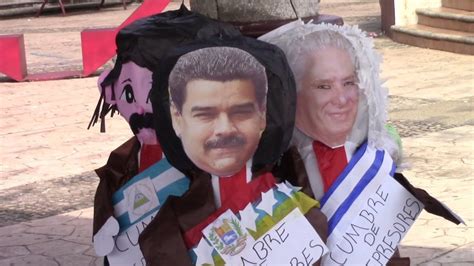 Migrantes queman piñatas de presidentes en protesta contra la cumbre