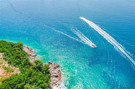 Premium Photo Two Boats Floating Near A Rocky Shore