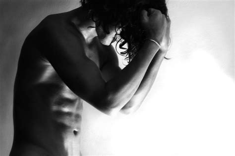 Premium Photo Frustrated Naked Man Standing Against Wall At Home