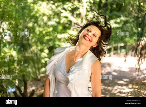Cute Mature Woman Shakes Her Hair In A Garden Stock Photo Alamy