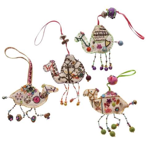 Three Ornaments Are Hanging From Strings And Decorated With Beads