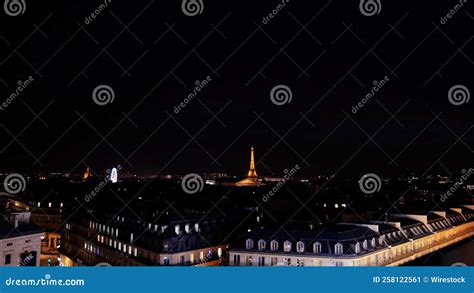 Aerial View Of Paris Cityscape With Illuminated Eiffel Tower At Night