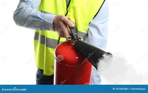 Worker Using Fire Extinguisher On Background Closeup Stock Photo