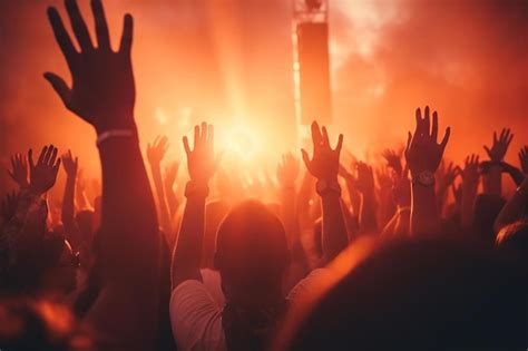 Premium AI Image | a crowd of people raising their hands at a concert