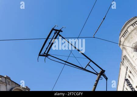 Tram Overhead Electrical Wires In Front Of A Building Facade Milan